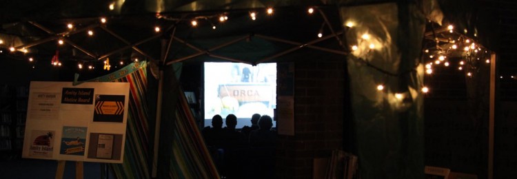 View of people watching the movie - through the decorated Amity Beach Bar